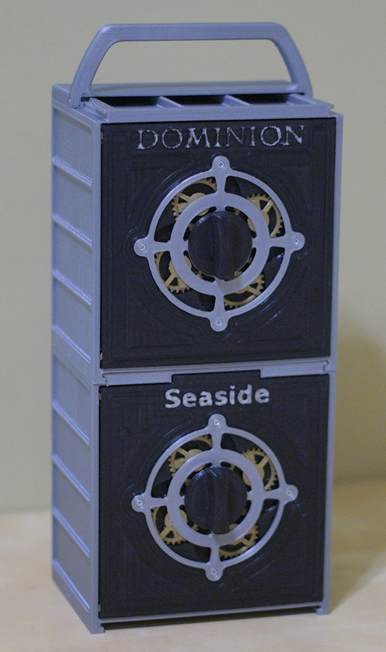 Black and silver storage boxes for Dominion and the Seaside expansion stacked with a handle on top