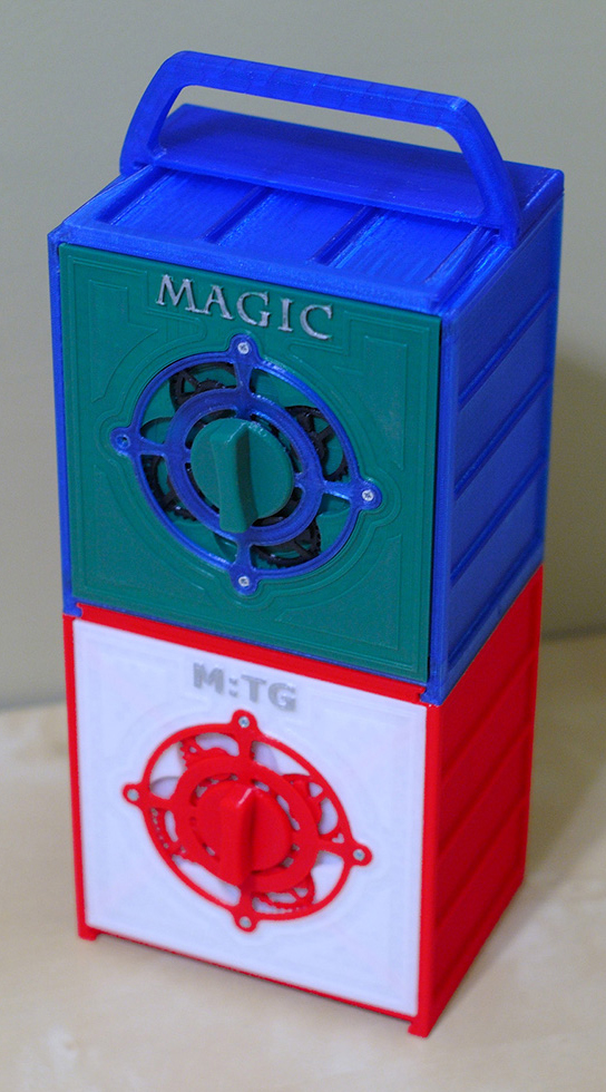 Two multicolored storage boxes for Magic: The Gathering decks, stacked with a handle on top