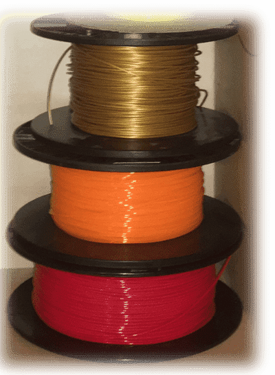 a stack of red, orange, and gold PLA filament spools
