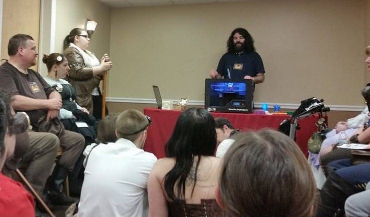Justin demonstrating the 3D printer to a group at The Steampunk World's Fair
